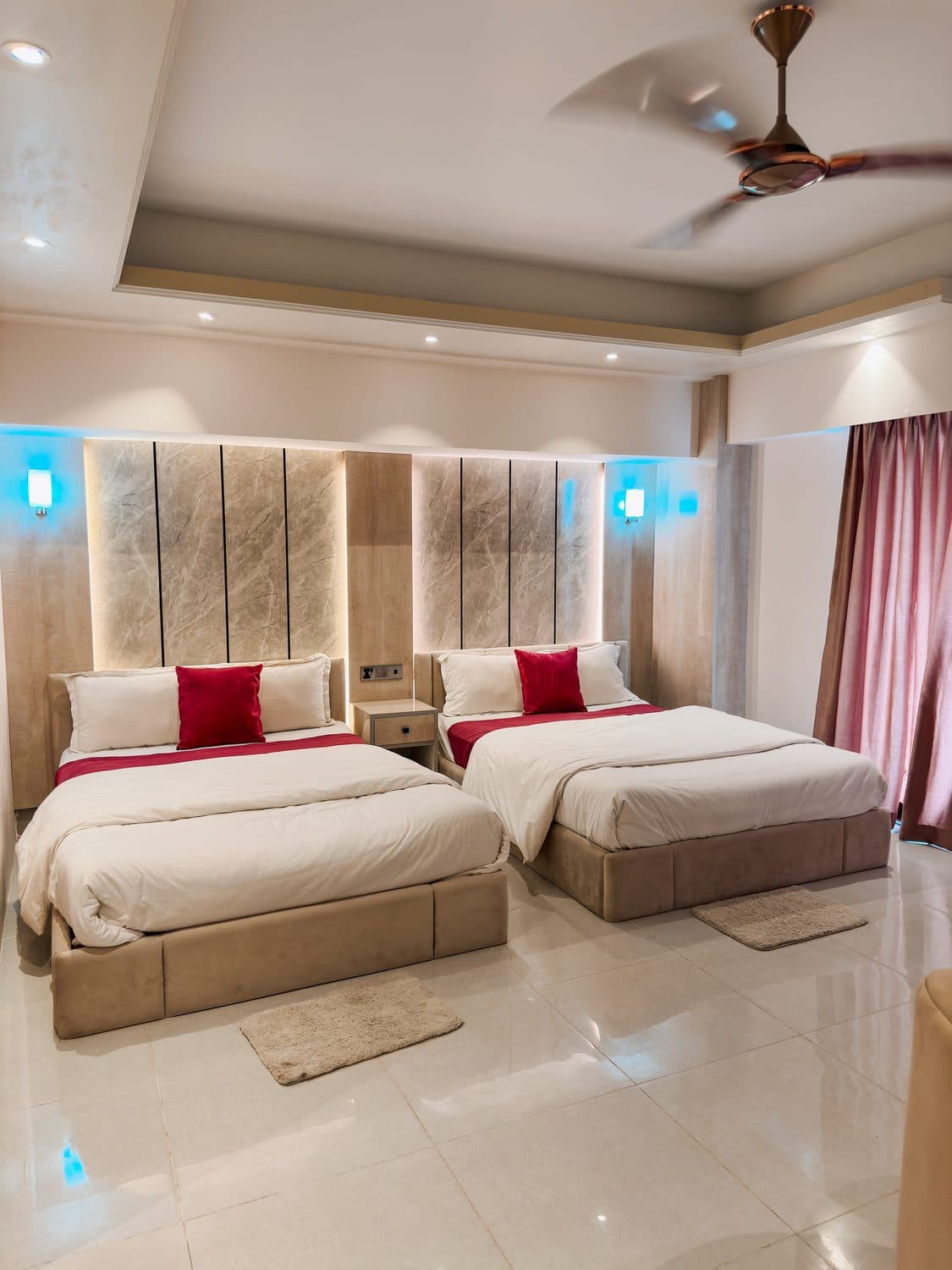 Premium VIP twin suite with a backlit marble headboard