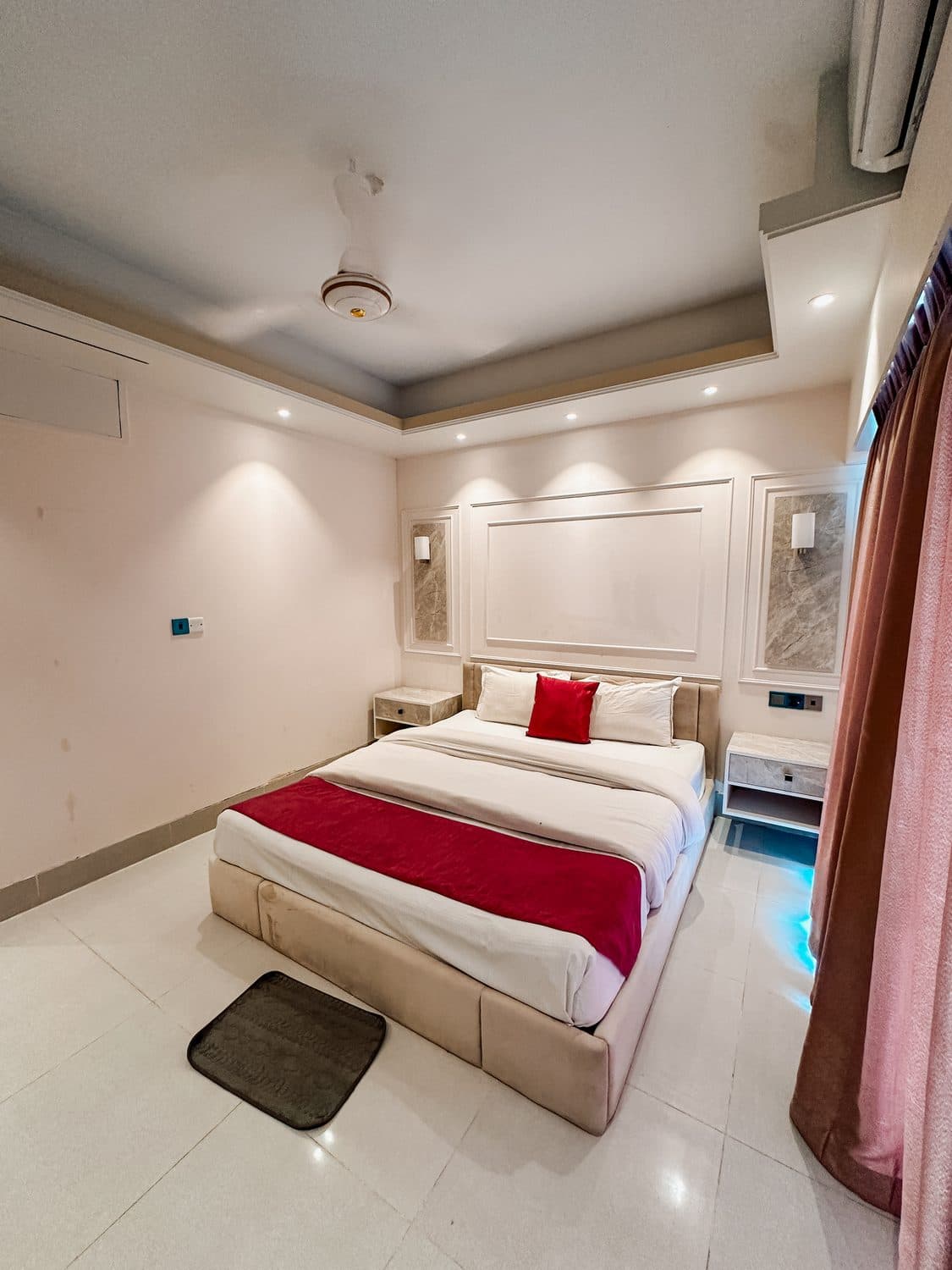 Couple suite softened by evening drapes